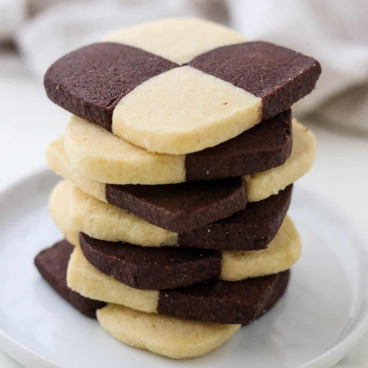 Several checkerboard cookies stacked on top of one another